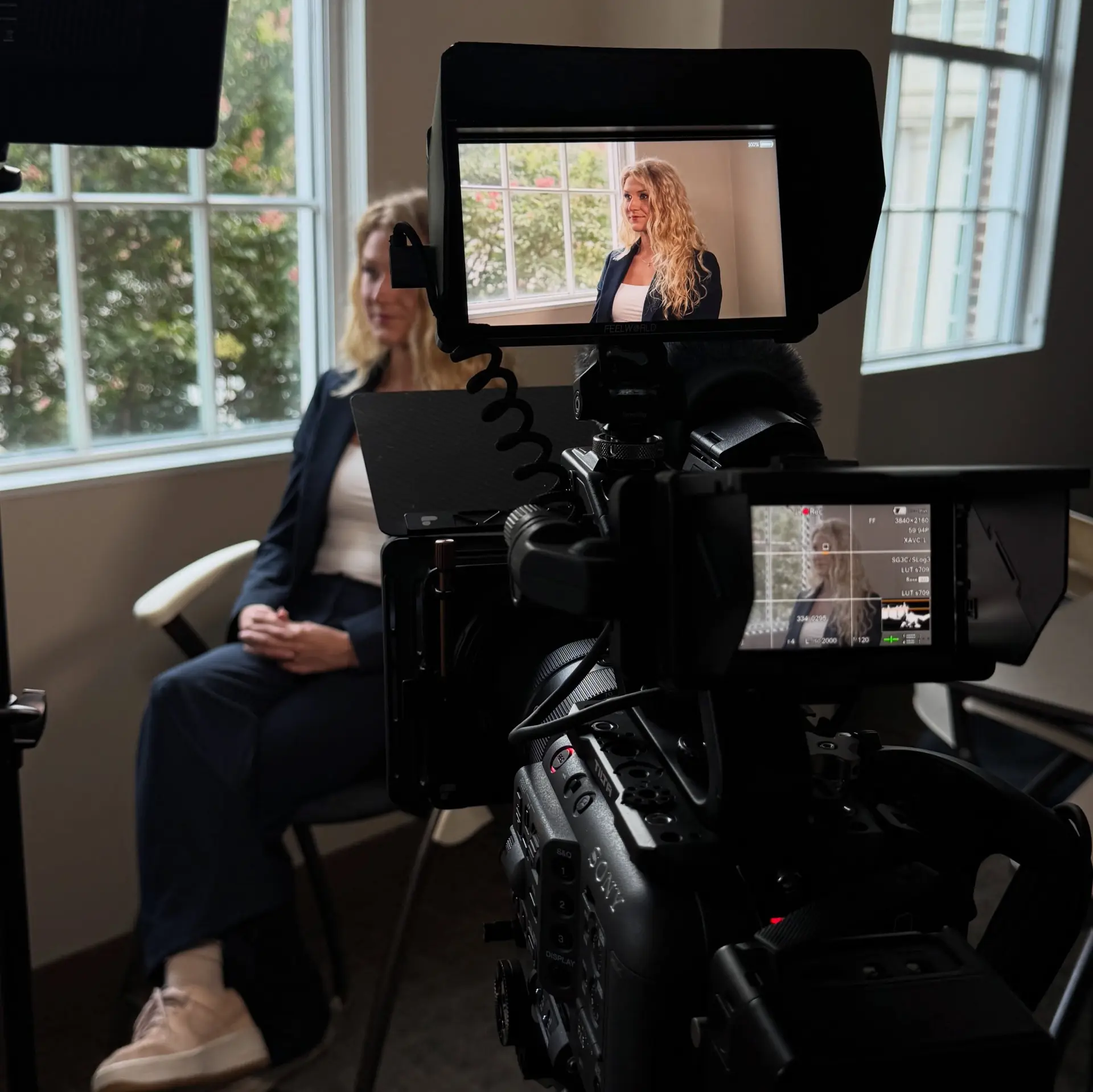 Hilltree interview lit by window light, subject visible on the camera monitor